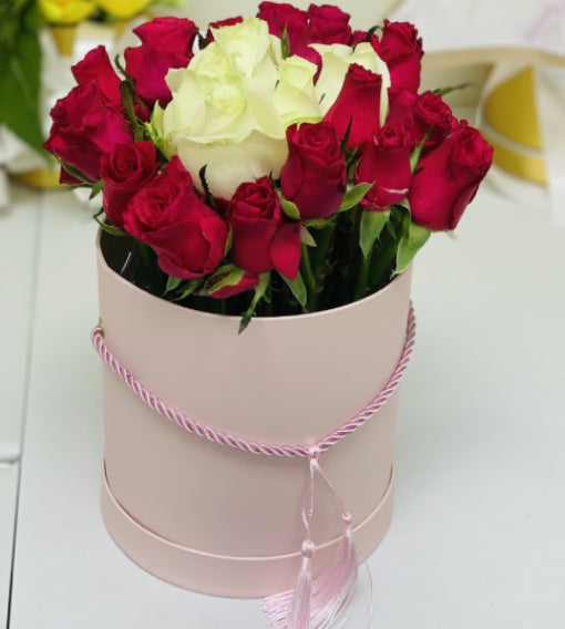 Pink and white roses in a pink  box